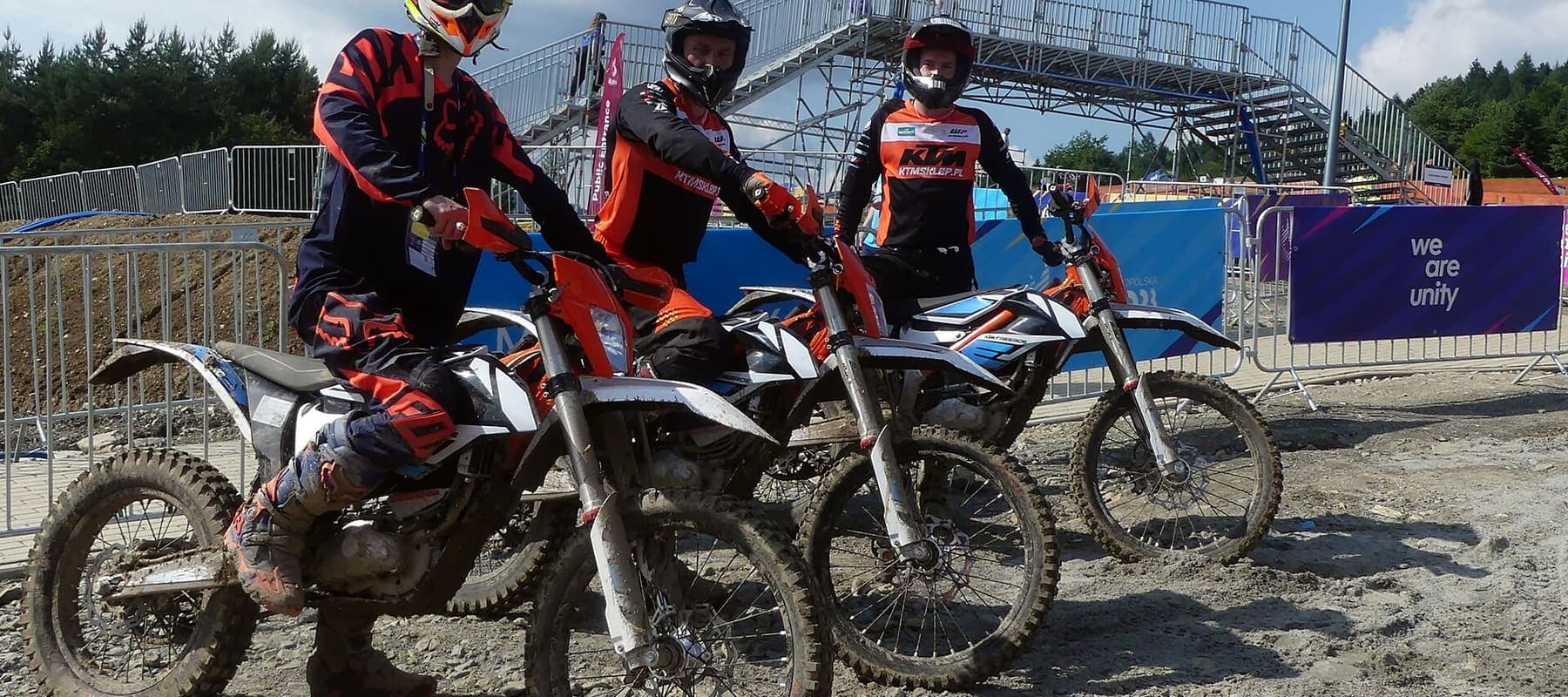 Riders on electric off-road bikes at an MX track